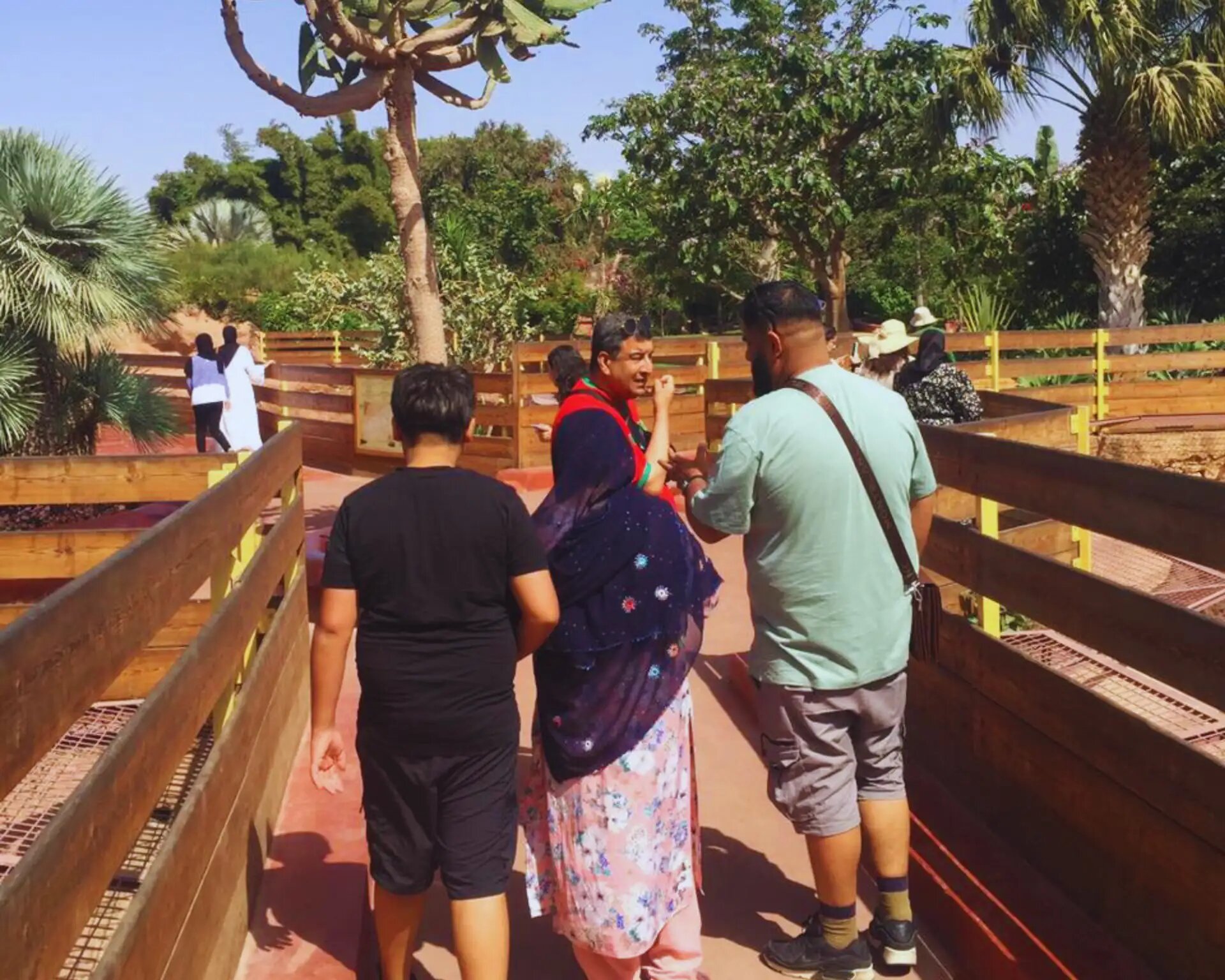 Family walking along the wooden paths of Crocoparc Agadir's gardens