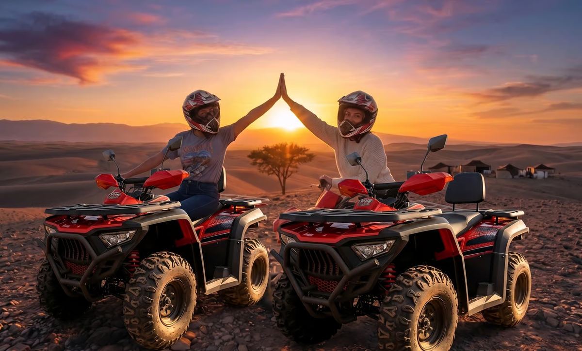 Two quad riders high-fiving at sunset in the Agafay desert