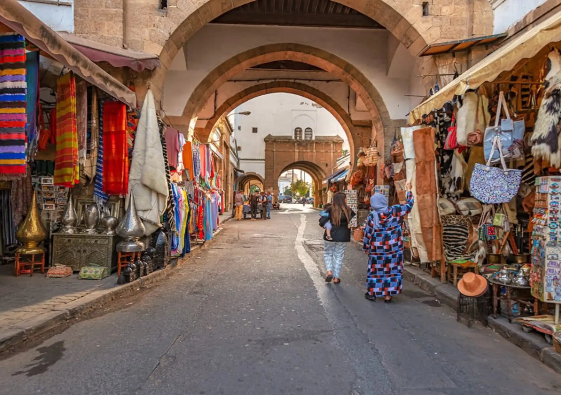 Shops with rugs, lanterns and handicrafts along an arched street in the Habous Quarter