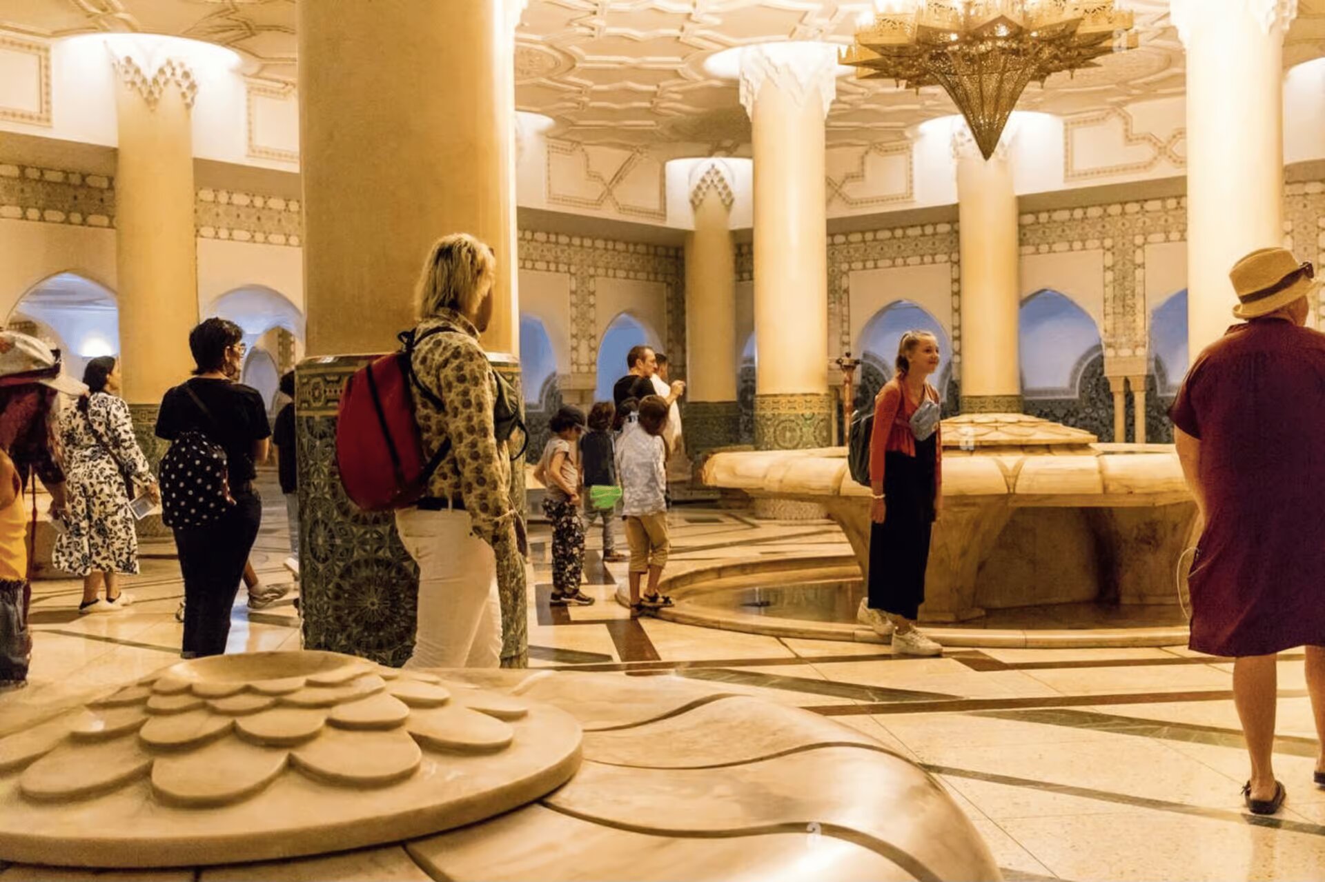 Visitors in the columned ablution hall beneath the Hassan II Mosque