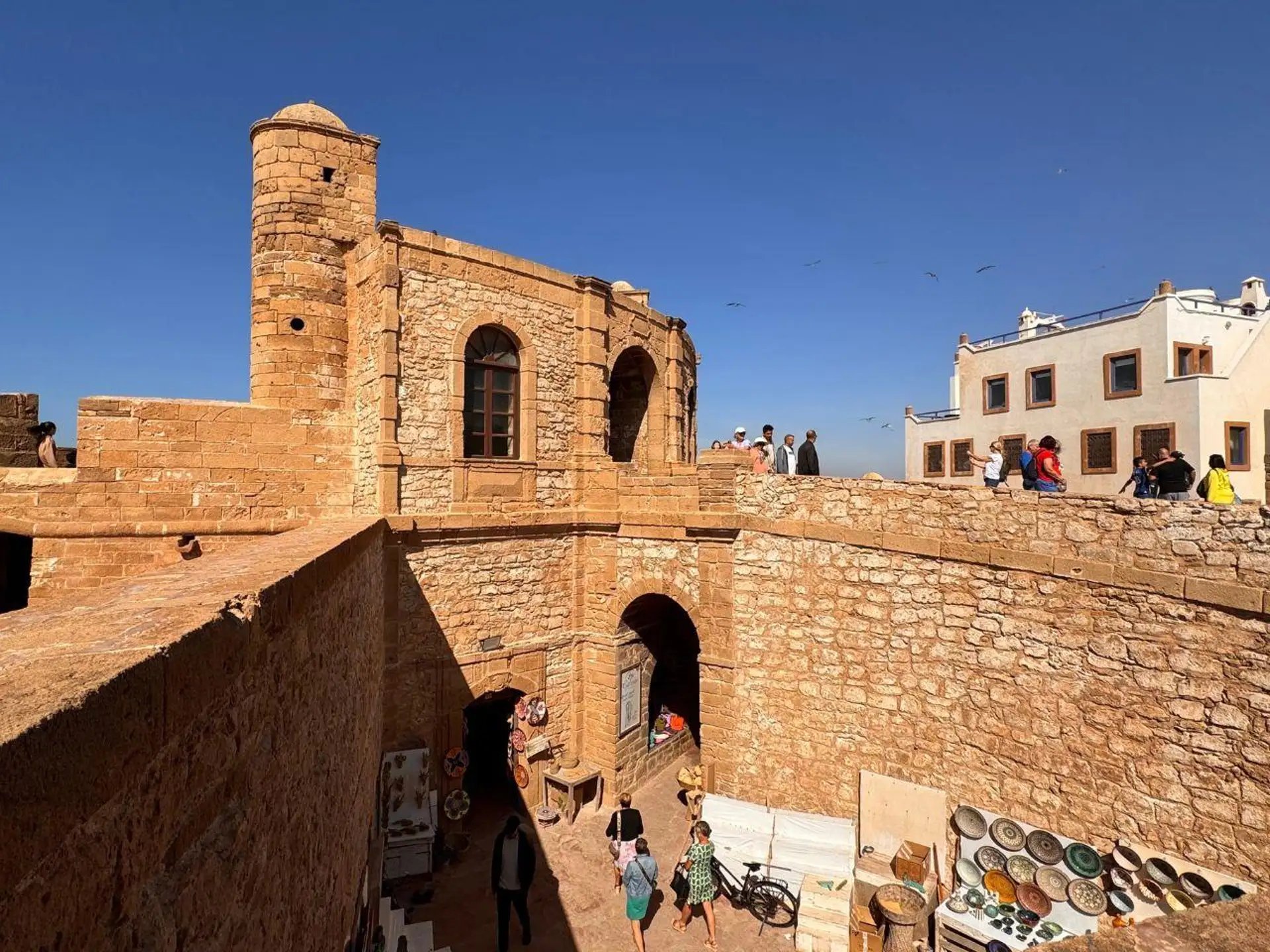 Stone bastion above a lane of pottery and handicraft shops in Essaouira