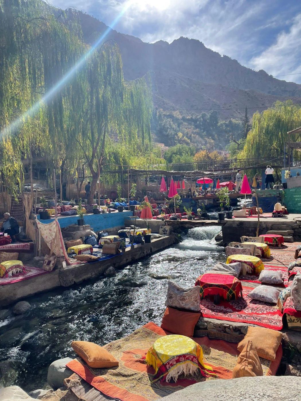 Colorful riverside cafés along the Ourika River beneath the Atlas Mountains