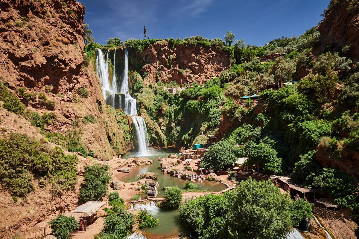 Panoramic view of the Ouzoud Waterfalls cascading into the green gorge