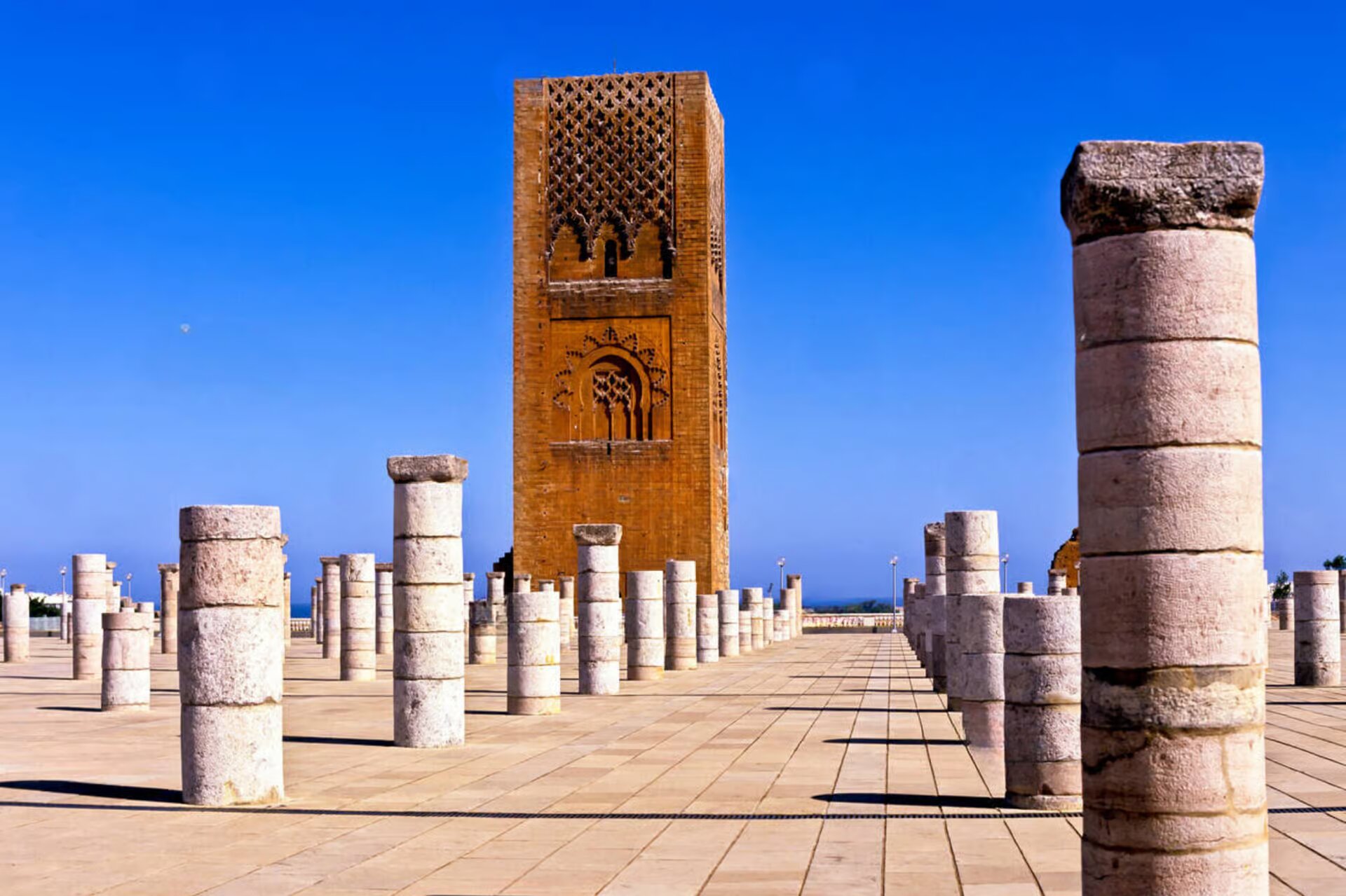 Hassan Tower and rows of ancient stone columns under a deep blue sky in Rabat
