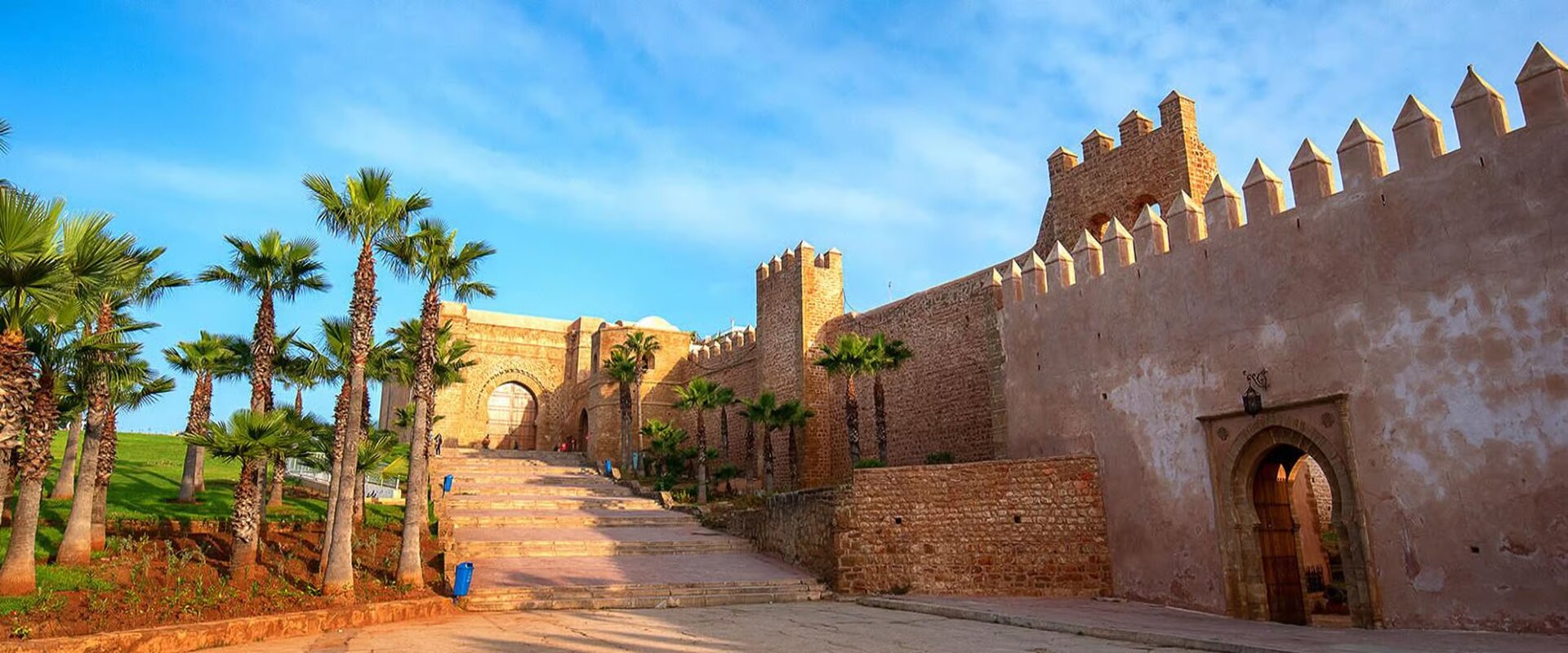 Crenellated ochre walls and palm trees along the historic ramparts of Rabat