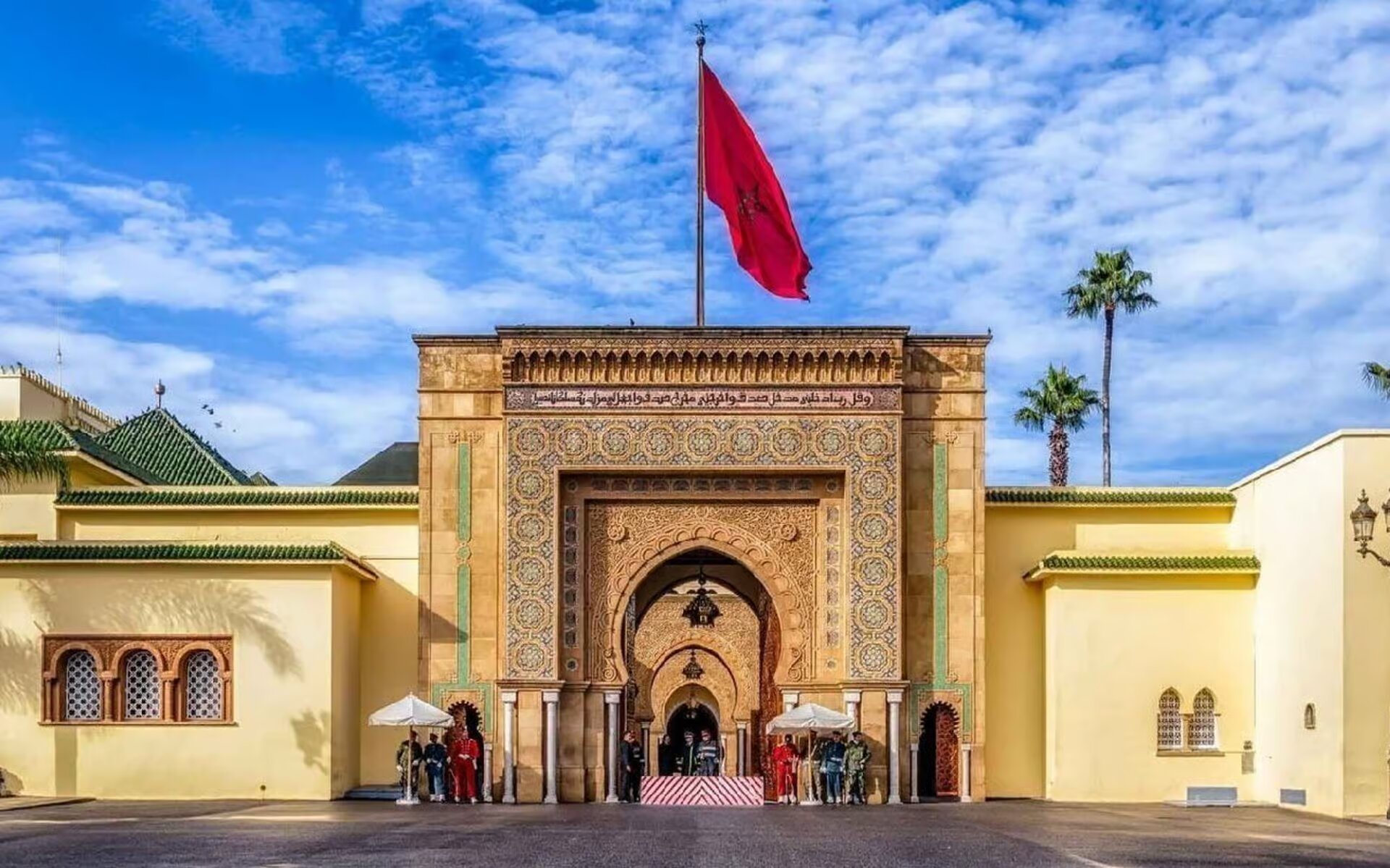 Moroccan flag above the ornate gate of the Royal Palace in Rabat